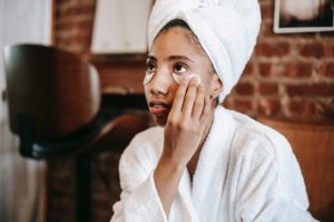 Girl applying wrinkle cream