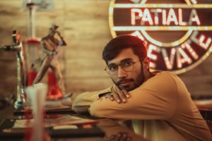 man in brown long sleeve shirt wearing black framed eyeglasses