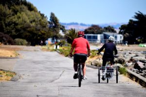 man in red shirt riding bicycle during daytime