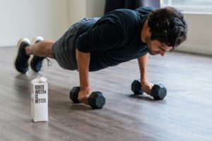 man in black t-shirt and black shorts doing push up