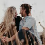 couple looking at each other while holding hands